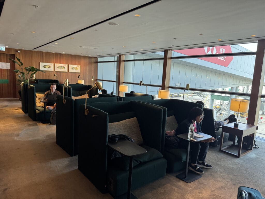 a group of people sitting in a room with green couches
