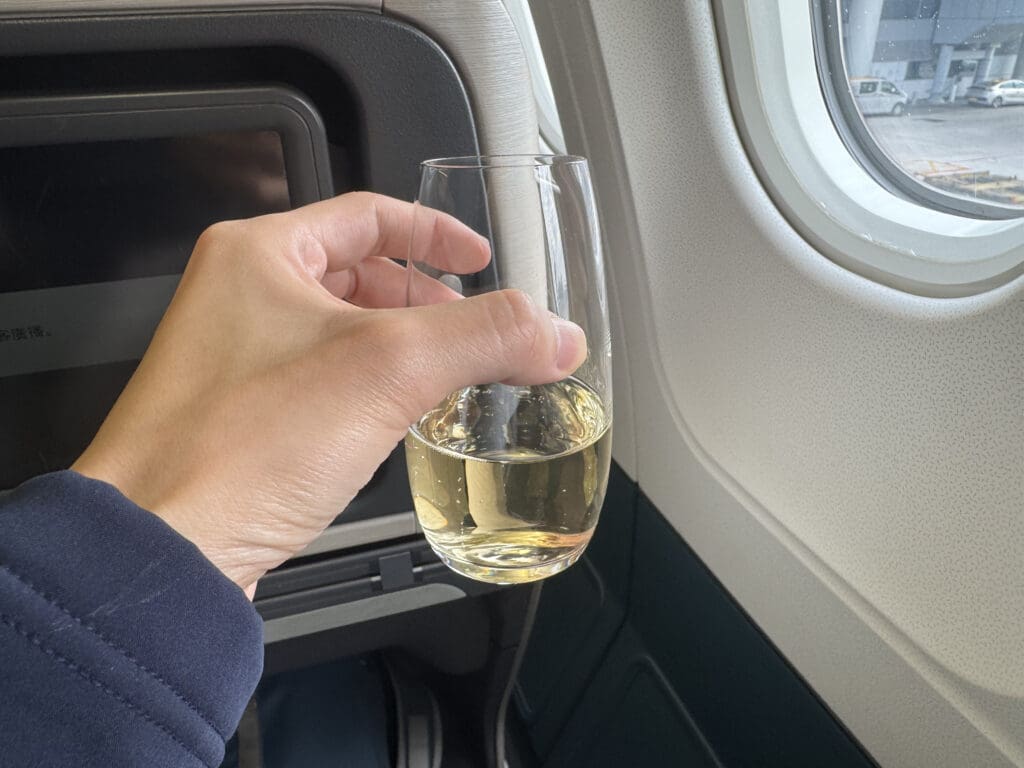 a hand holding a glass of wine