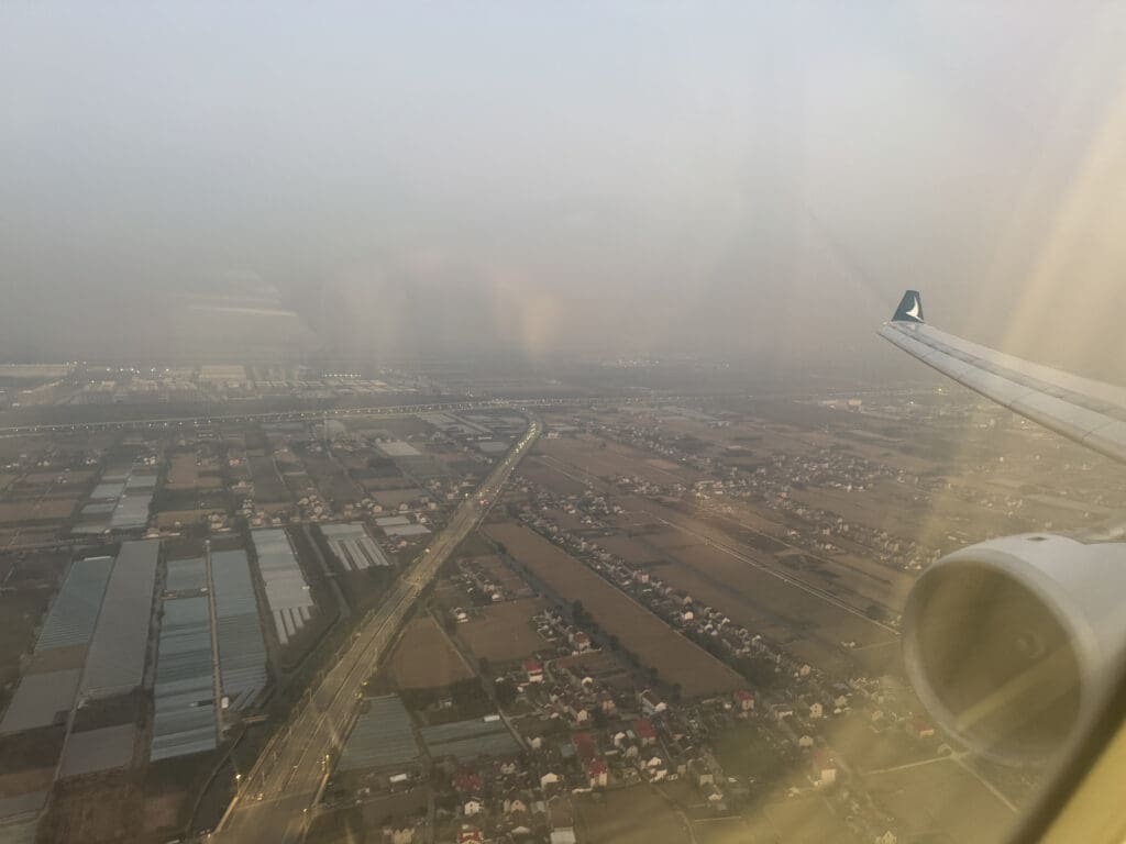 an airplane wing and a city