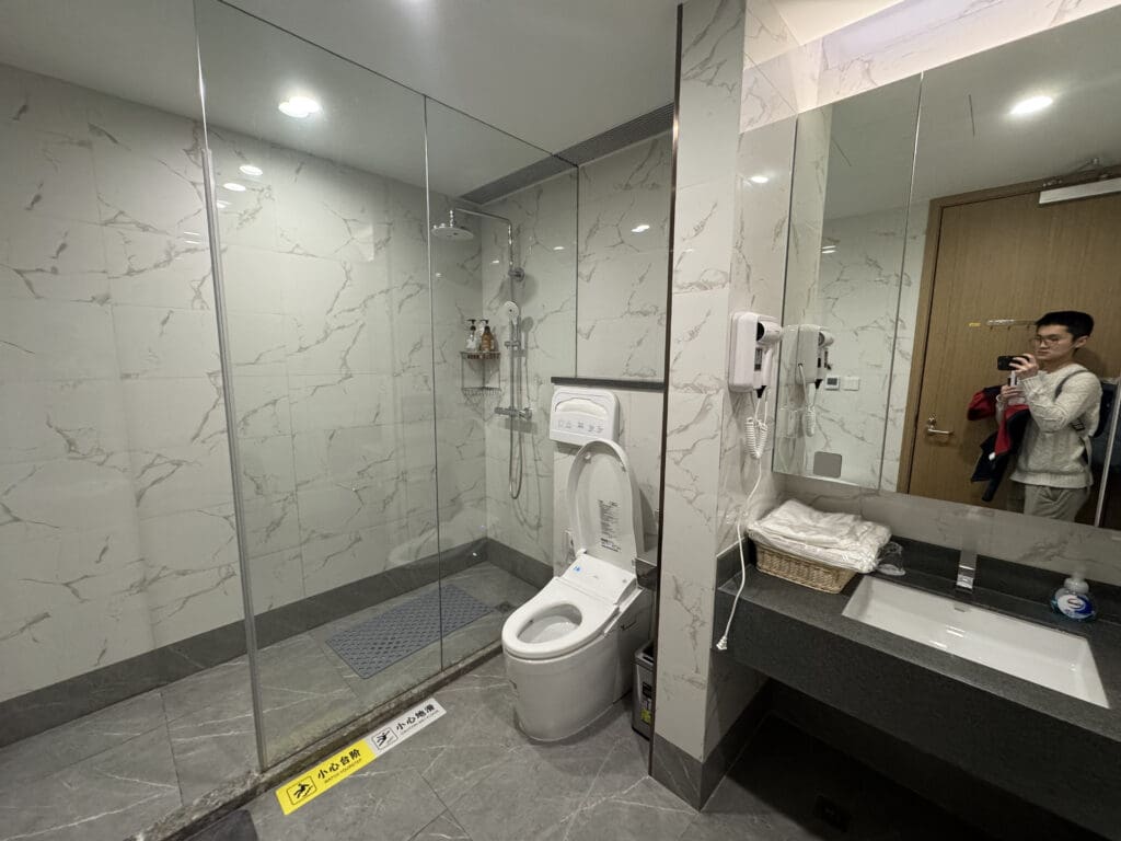 a bathroom with a glass shower and toilet