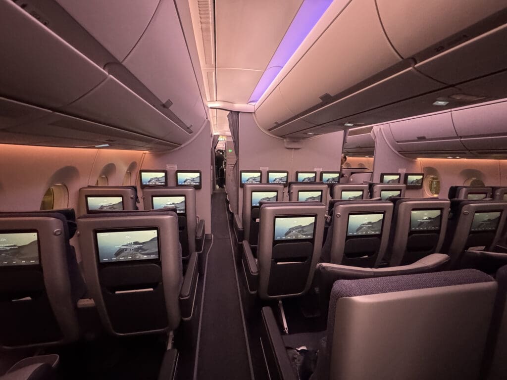 a row of seats with monitors on the side