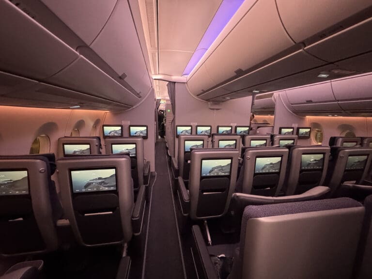 a row of seats with monitors on the side