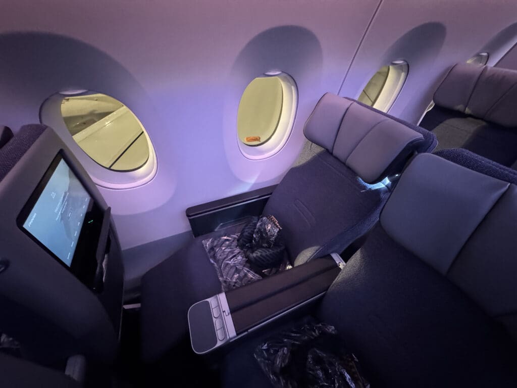 the inside of an airplane with seats and windows