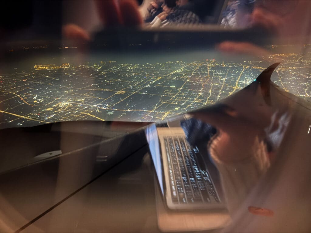 a reflection of a city on a glass surface