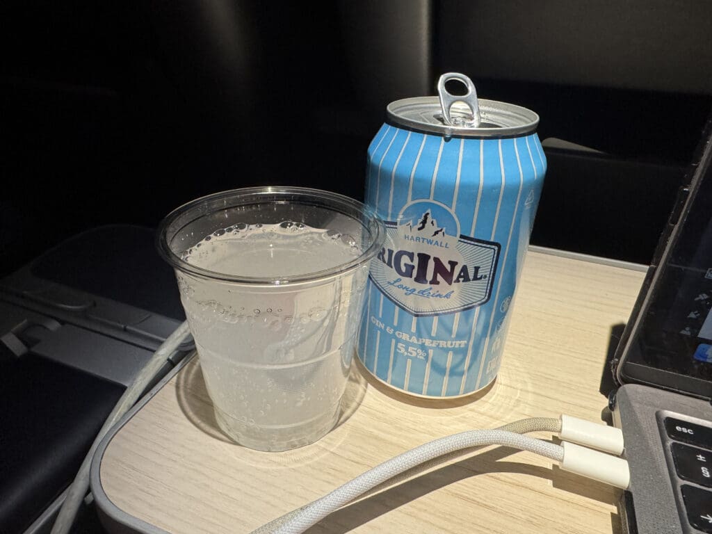 a can and a glass of liquid on a table