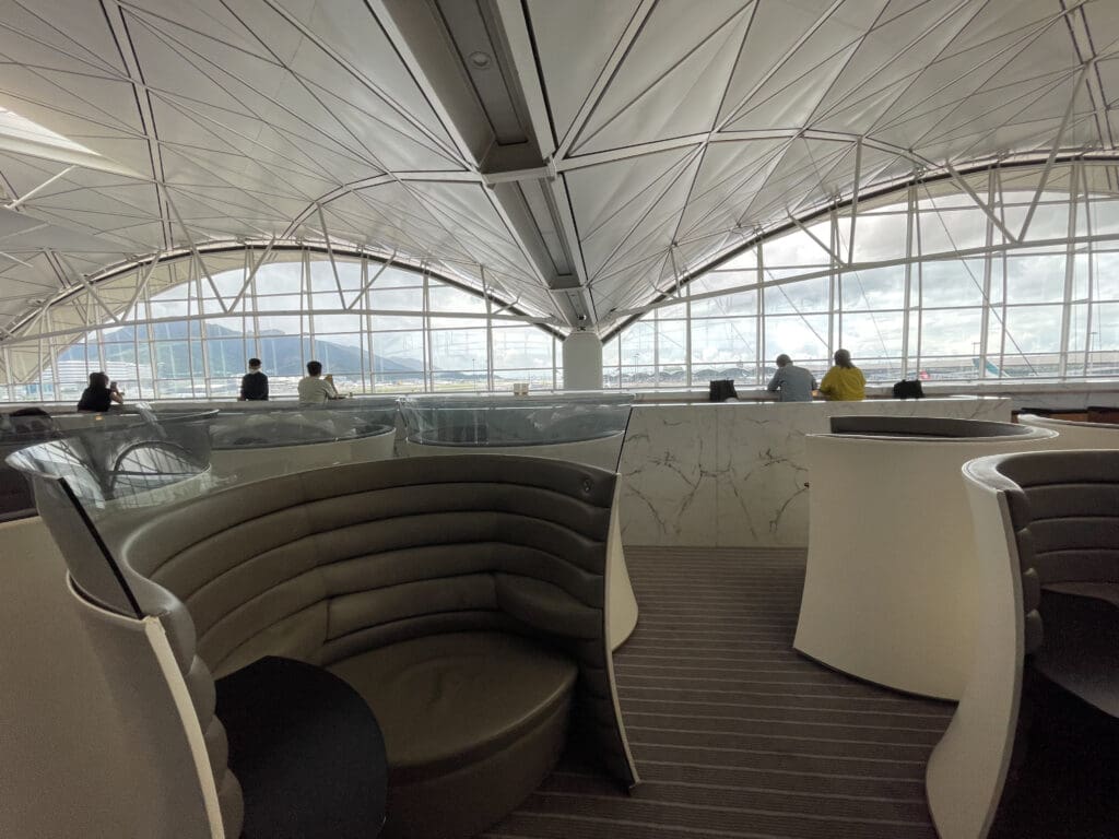 a group of people sitting in a room with a curved booth
