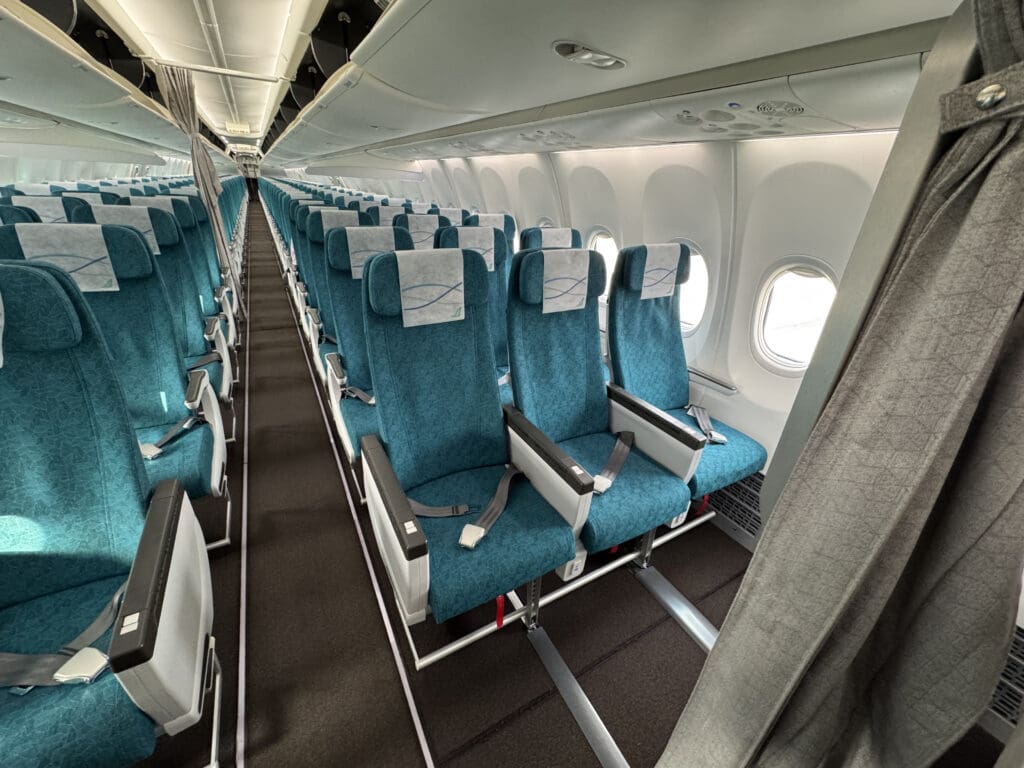 a row of blue seats in an airplane