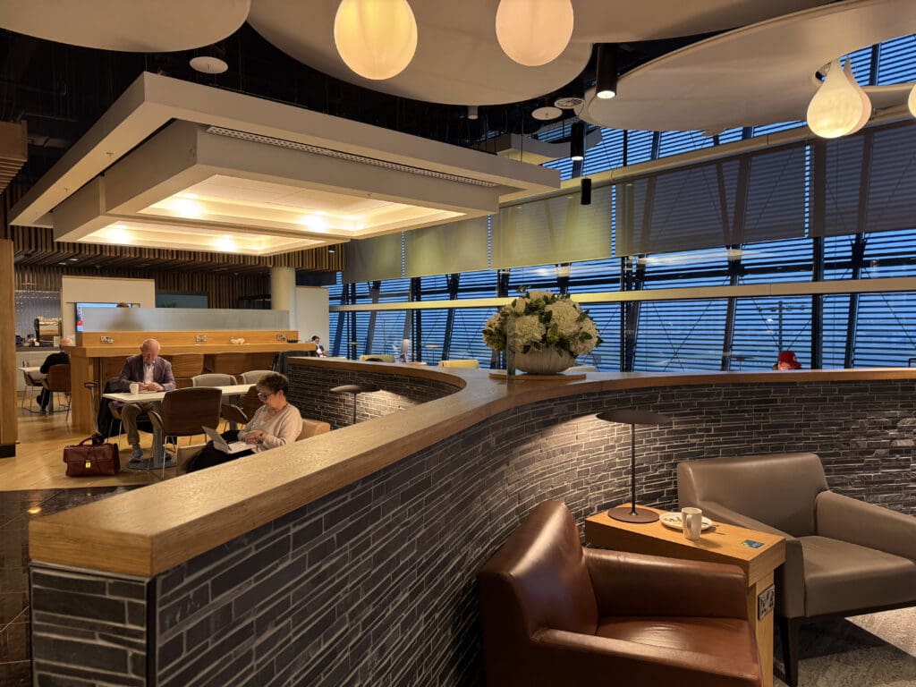 a room with a bar and chairs