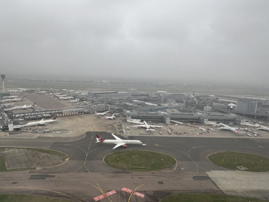 an aerial view of an airport with airplanes on the runway