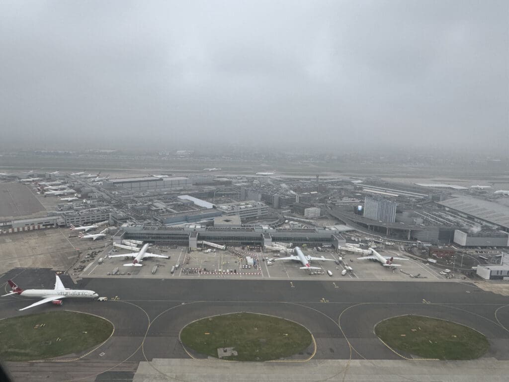an aerial view of an airport with planes on the runway