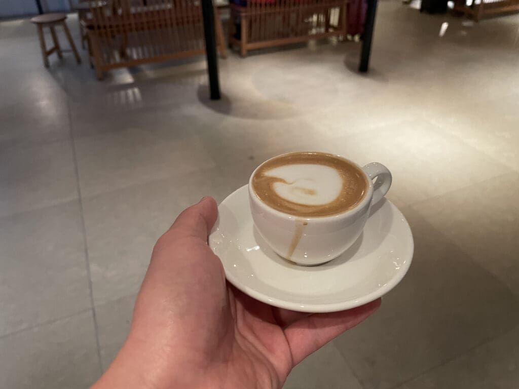 a hand holding a cup of coffee
