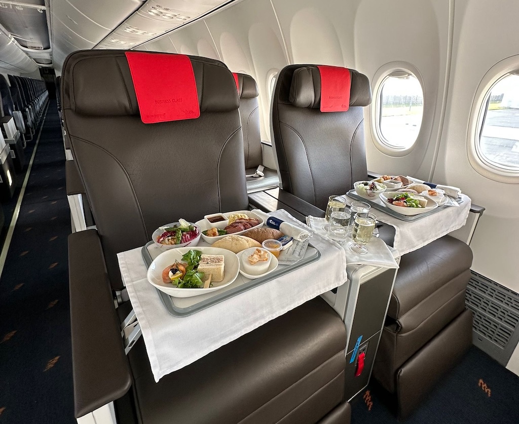 a tray of food on a table in an airplane