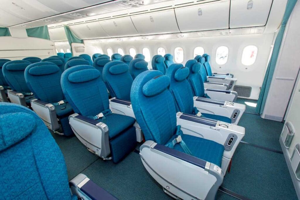a row of blue seats in an airplane