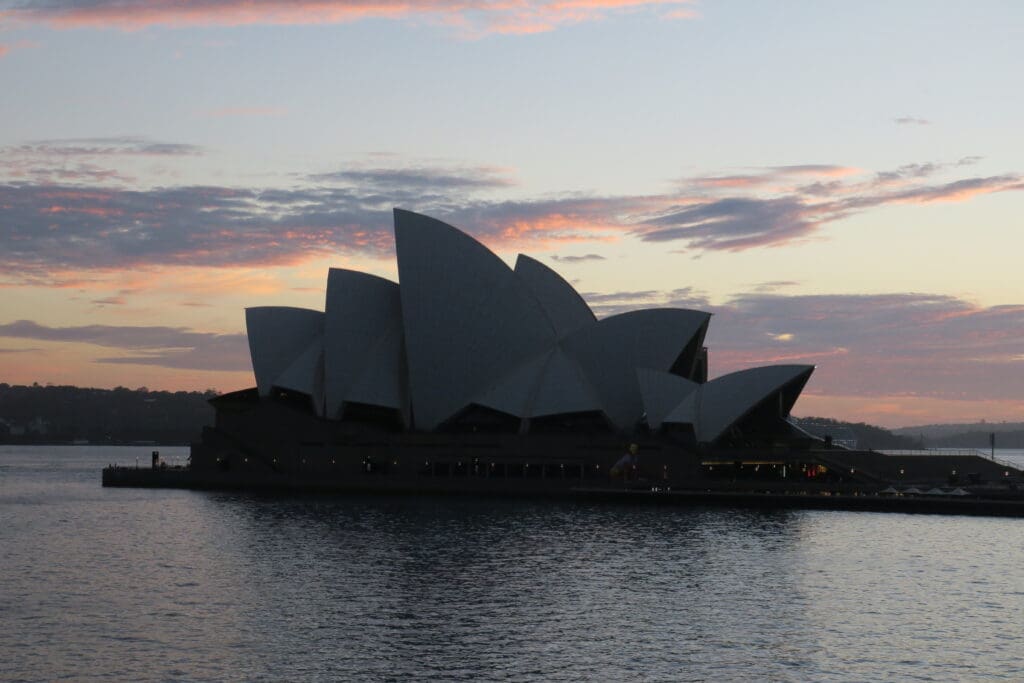 a building with pointed roof on water