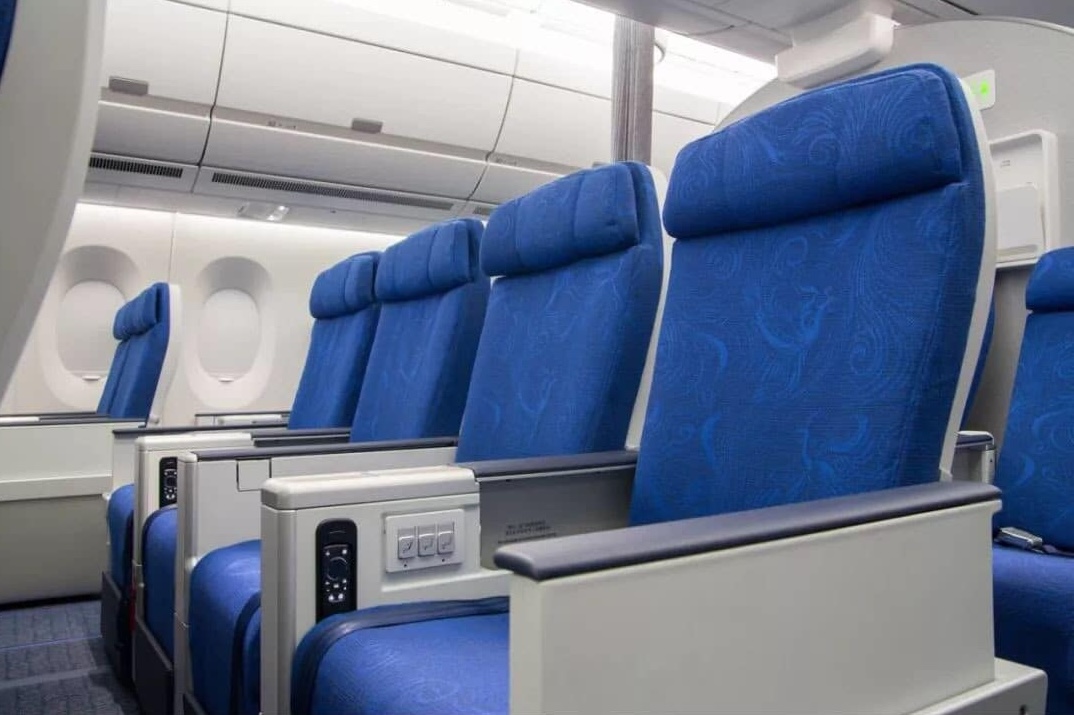 a row of blue seats in an airplane