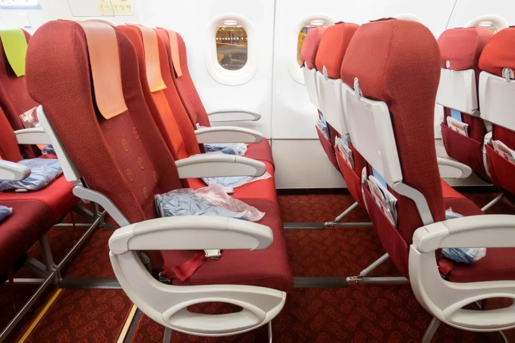 a row of red seats in an airplane