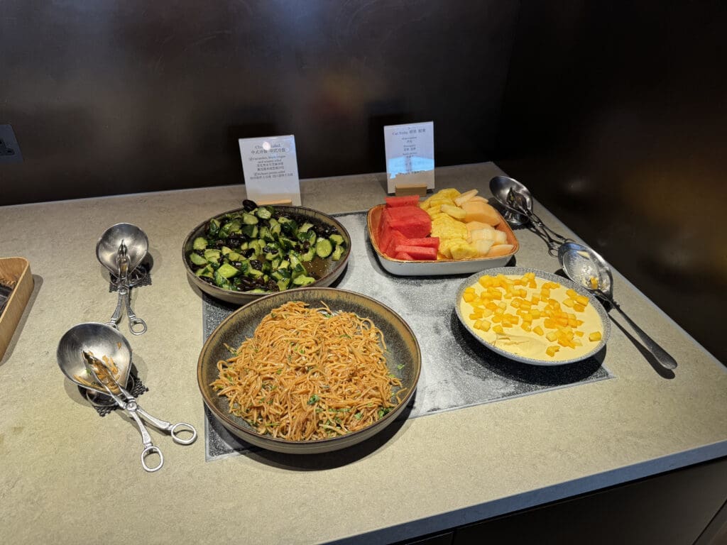 a table with bowls of food and spoons