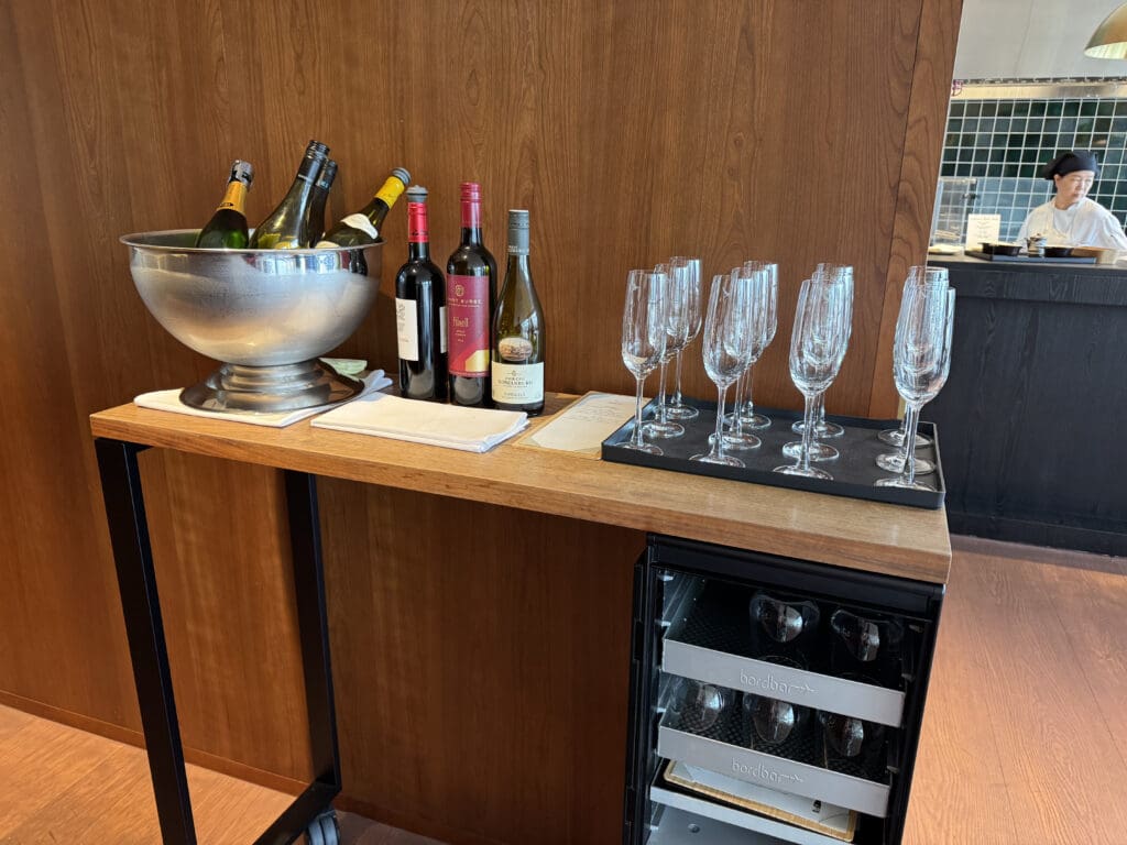 a table with wine bottles and glasses