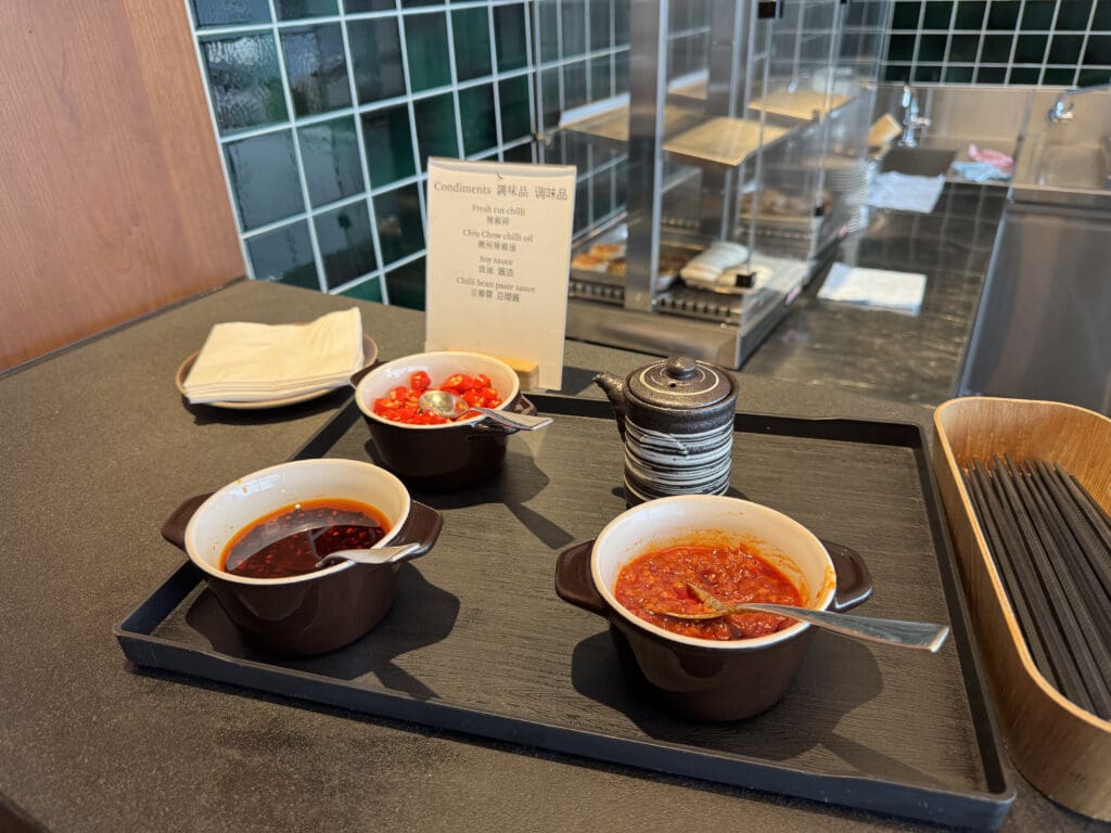 a tray with bowls of soup and a teapot on it