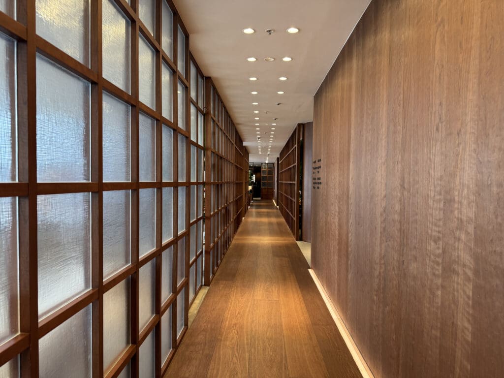 a long hallway with wood walls and a wood floor