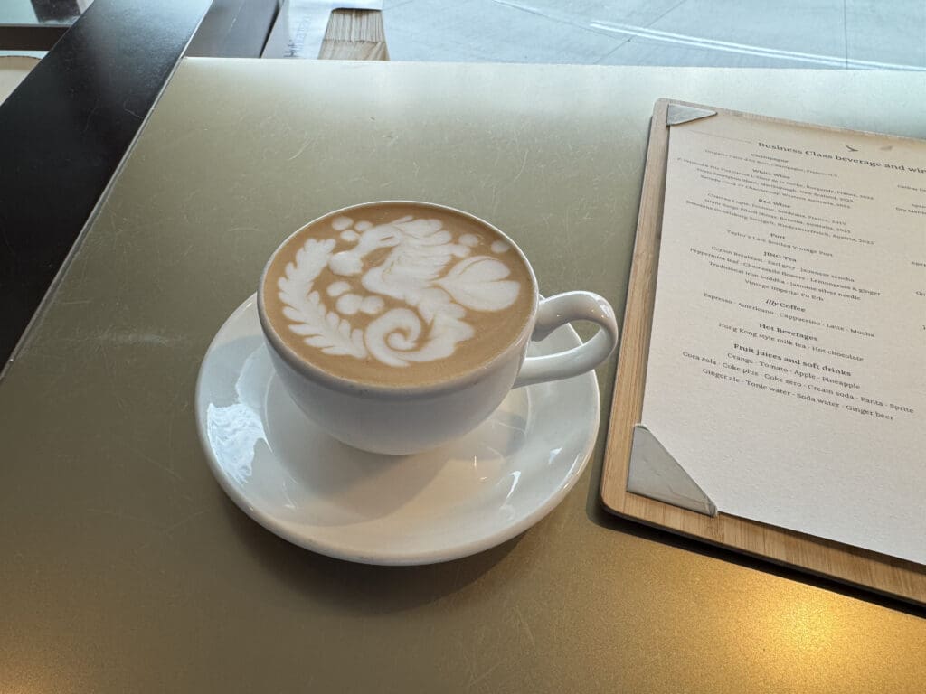 a cup of coffee with a design on the foam