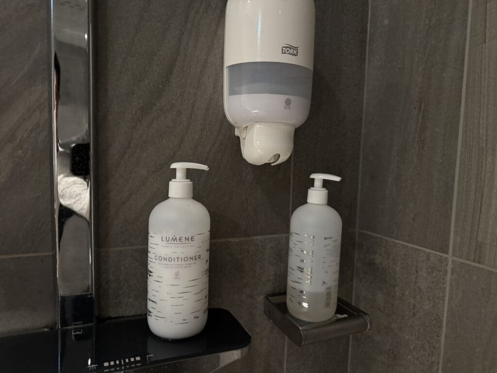 a group of soap dispensers on a wall