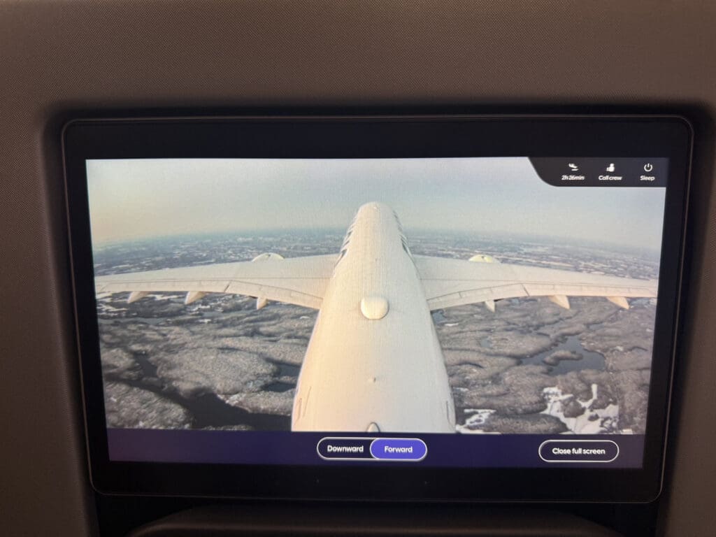 a screen with a plane flying in the sky