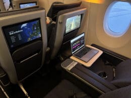 a laptop on a table in an airplane