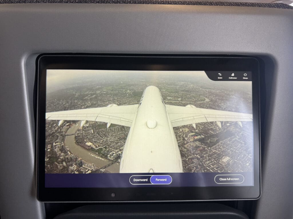 a screen with an airplane flying in the sky