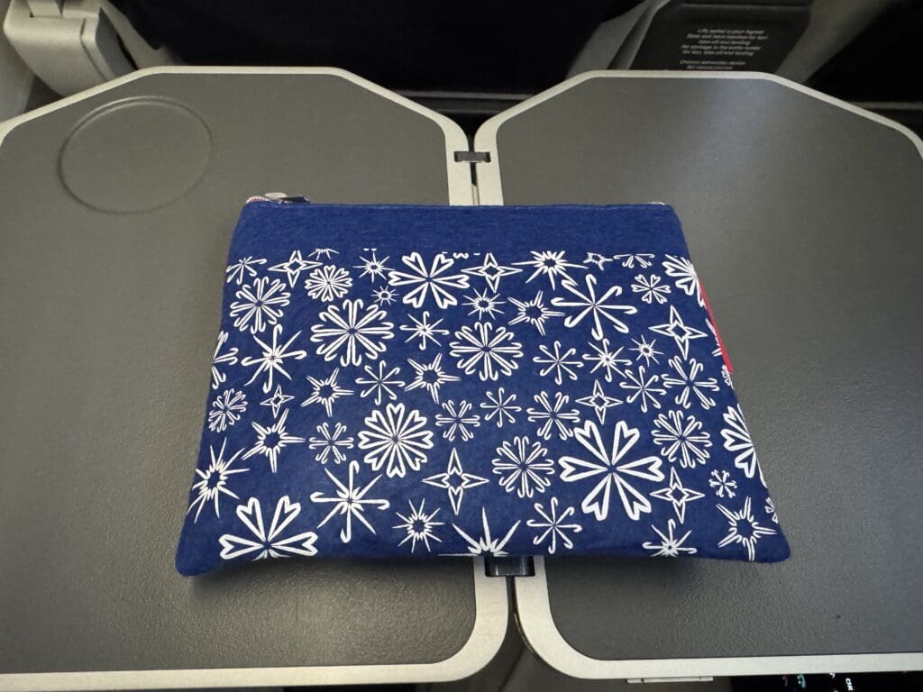 a blue and white bag on a grey seat