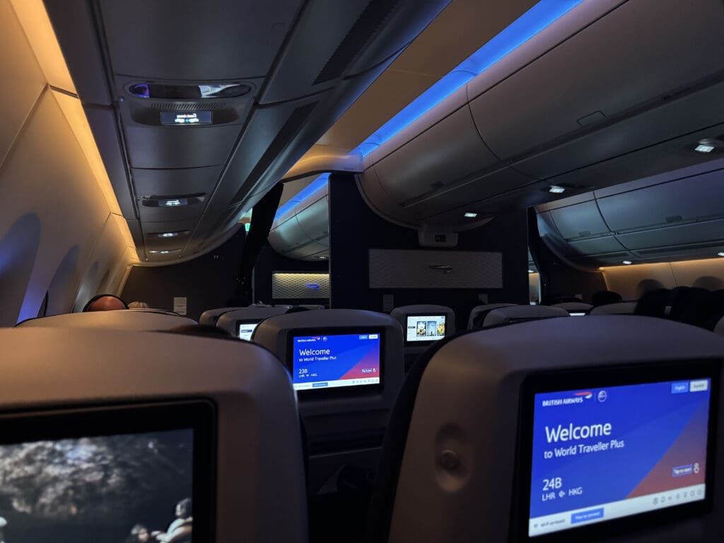 a seats and a screen on the back of a plane