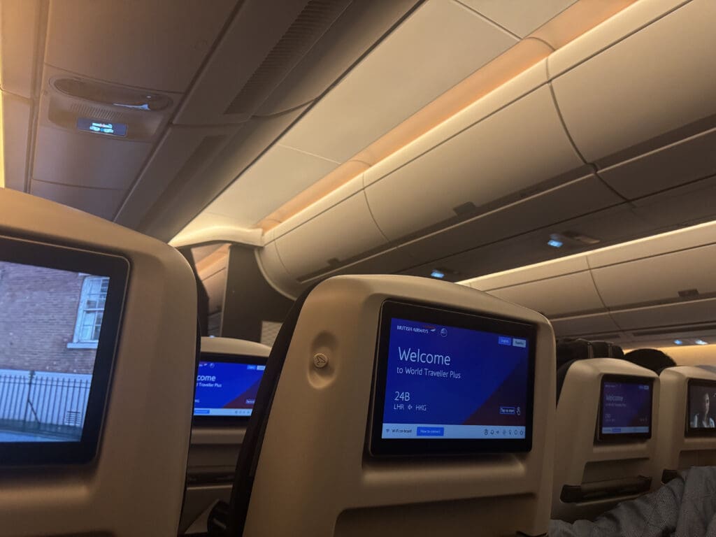a row of seats with monitors on the back