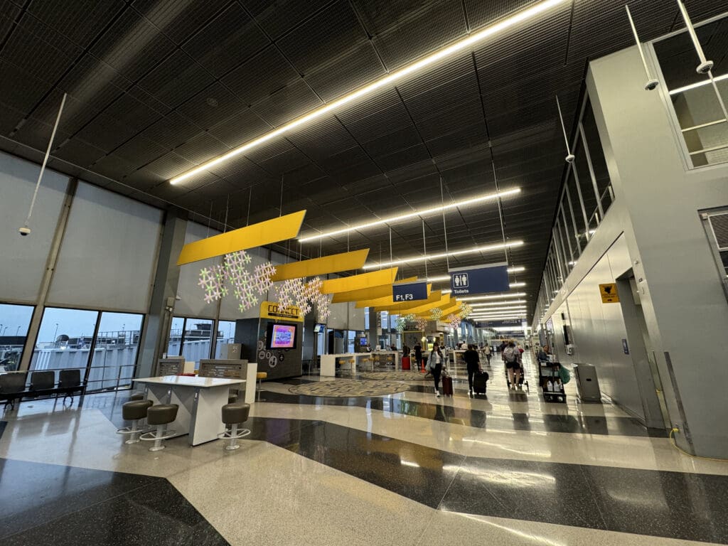 a large airport terminal with people walking around