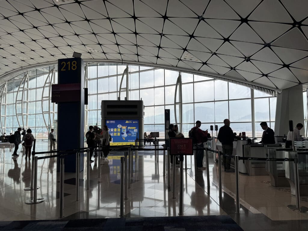people inside of a building with glass walls and a large window