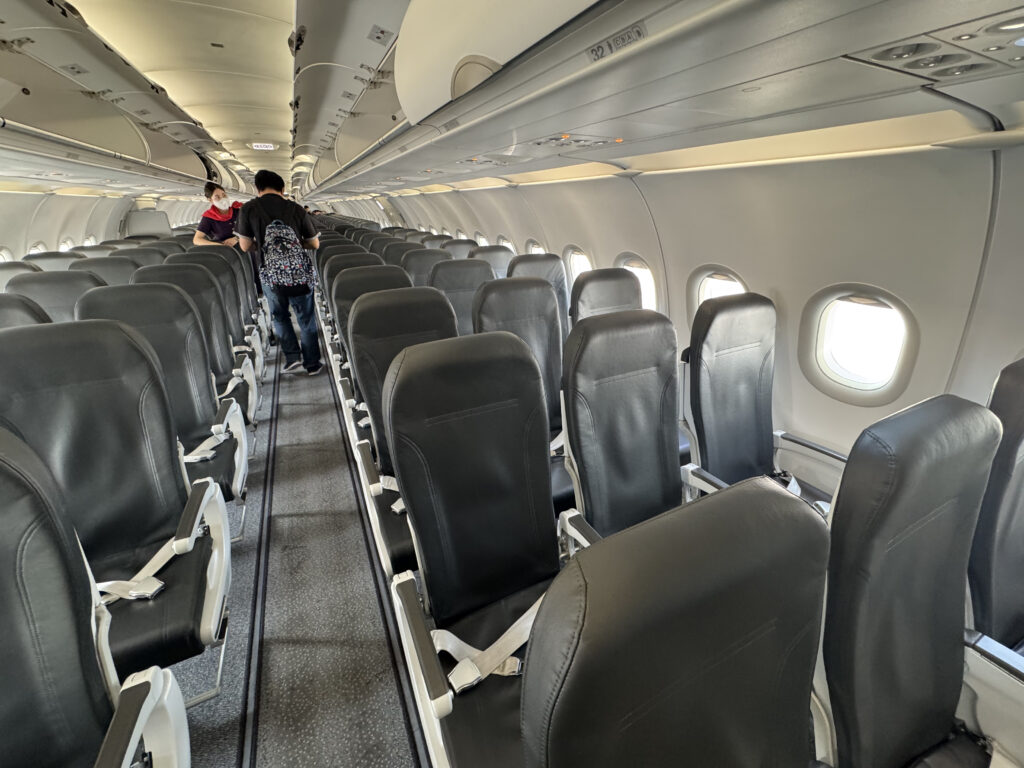 a plane with seats and people in the back