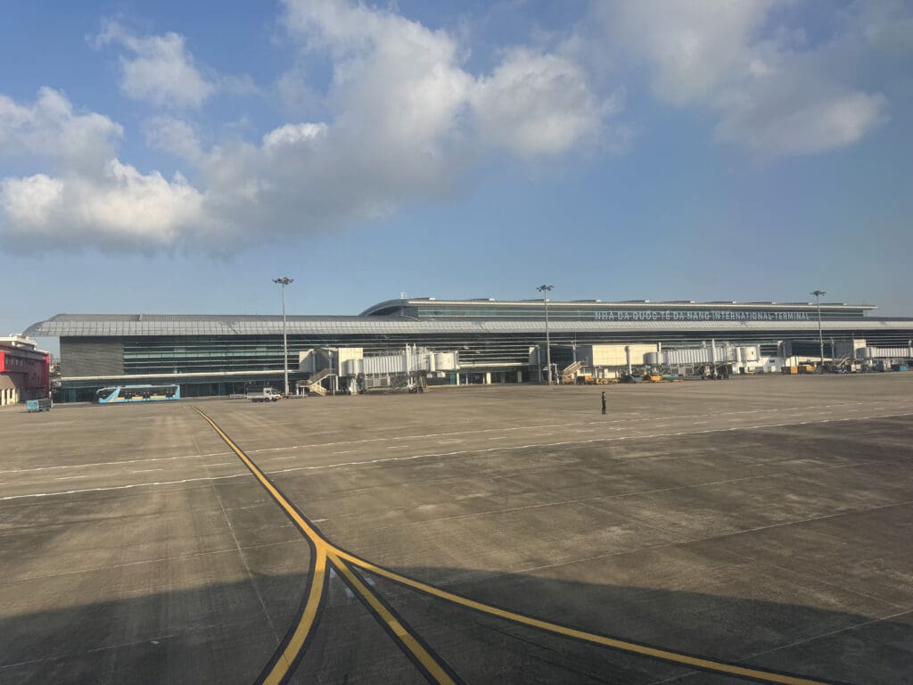 a large airport with a large building and a parking lot