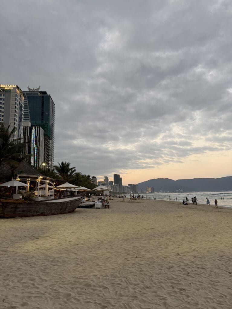 a beach with buildings and trees