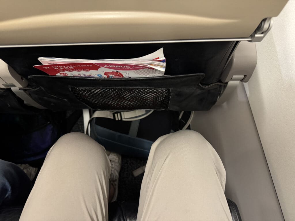 a person's legs in a pocket on an airplane