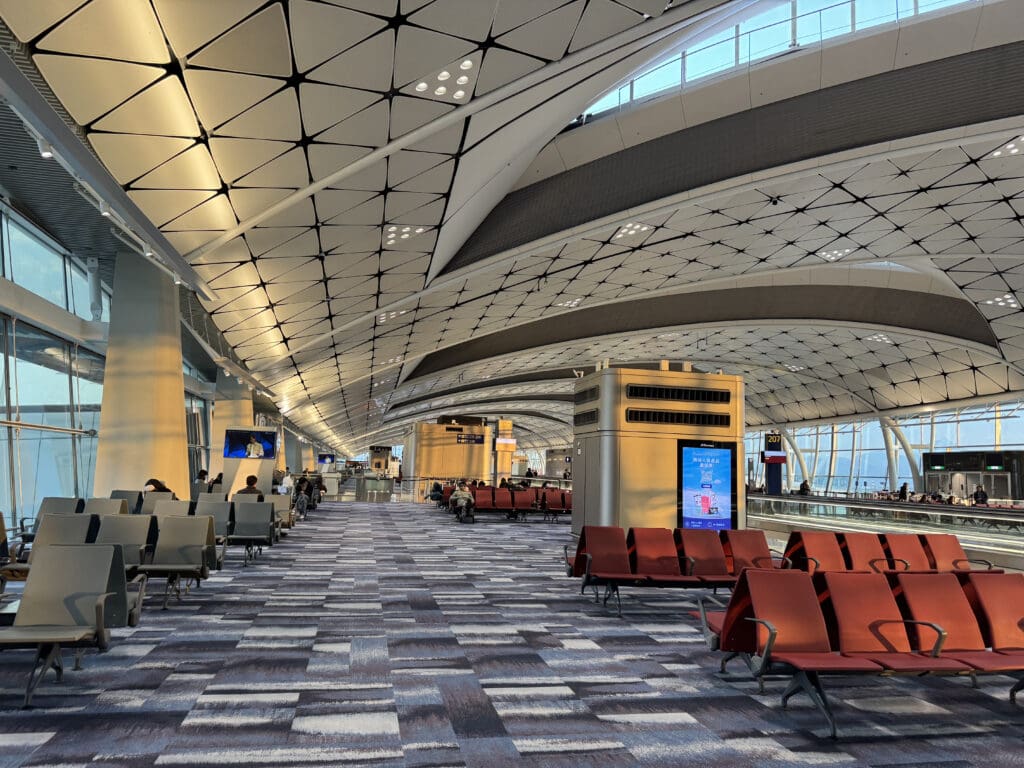 an airport with chairs and a large ceiling
