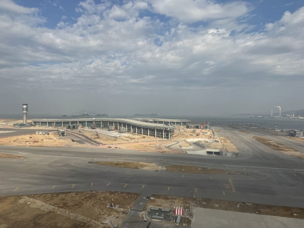 a construction site with a large building and a road