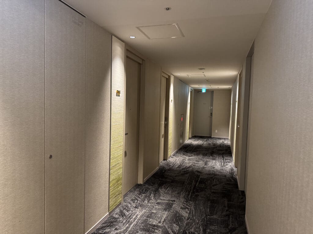 a hallway with doors and a carpeted floor