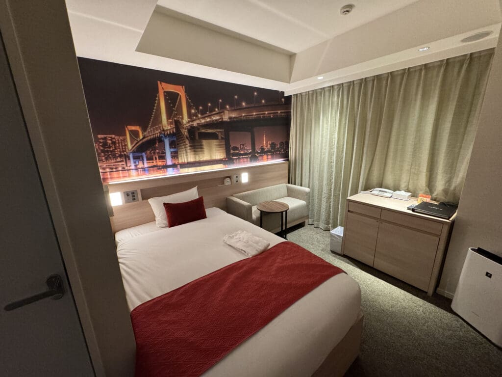 a bedroom with a bed and a picture of a bridge
