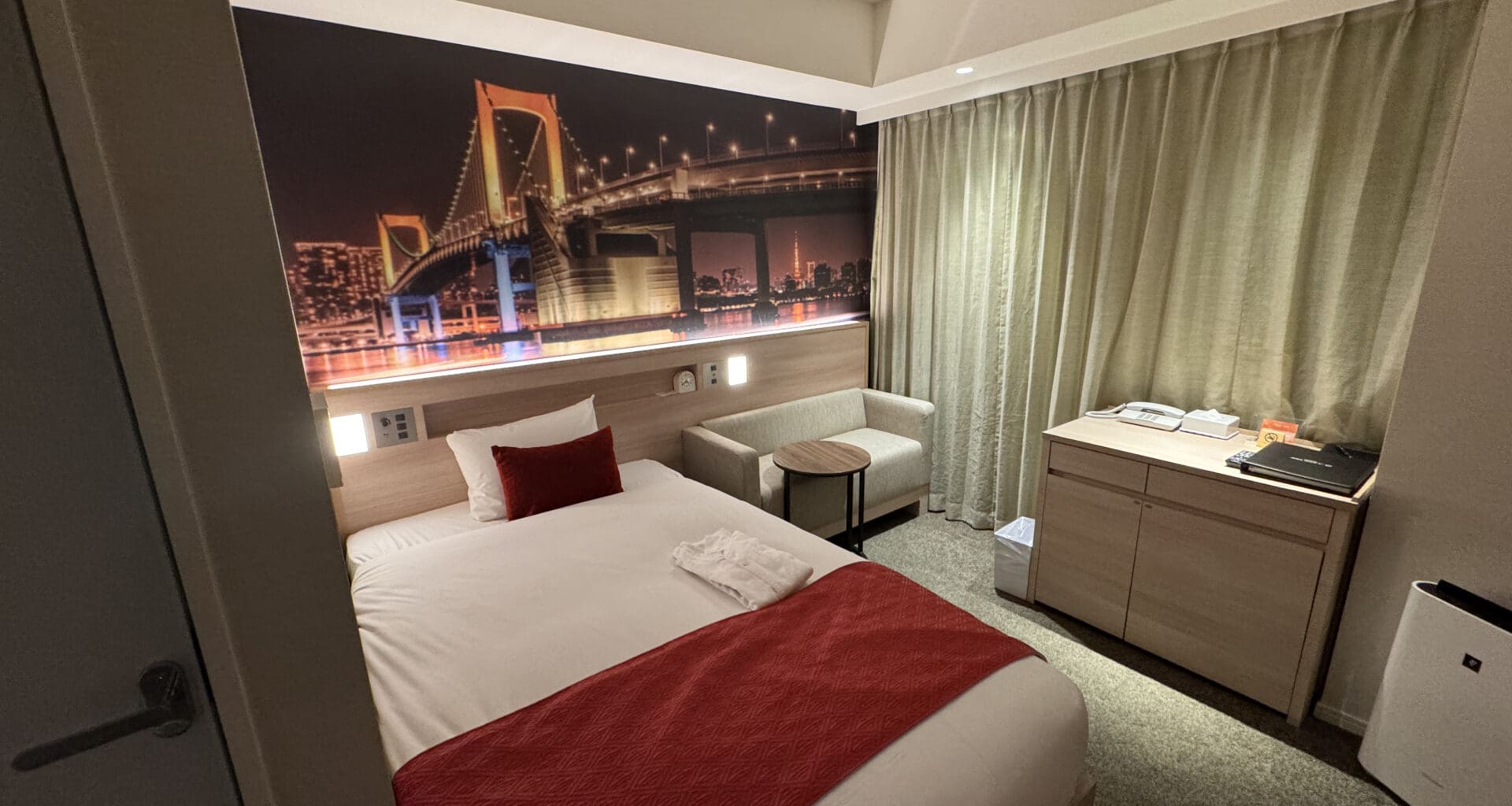 a bedroom with a bed and a picture of a bridge