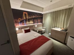 a bedroom with a bed and a picture of a bridge