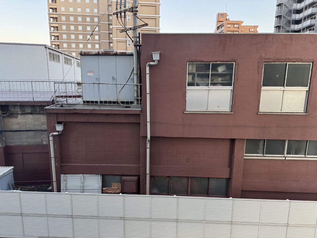 a building with a fence and a power line