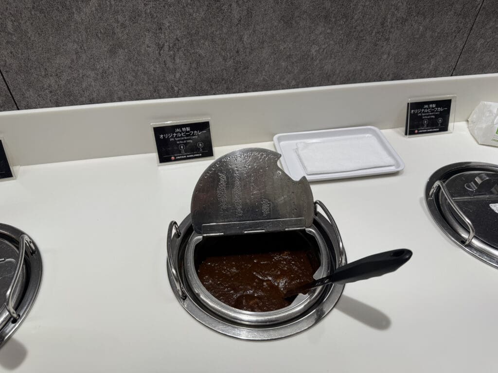 a bowl of brown liquid with a spoon in it