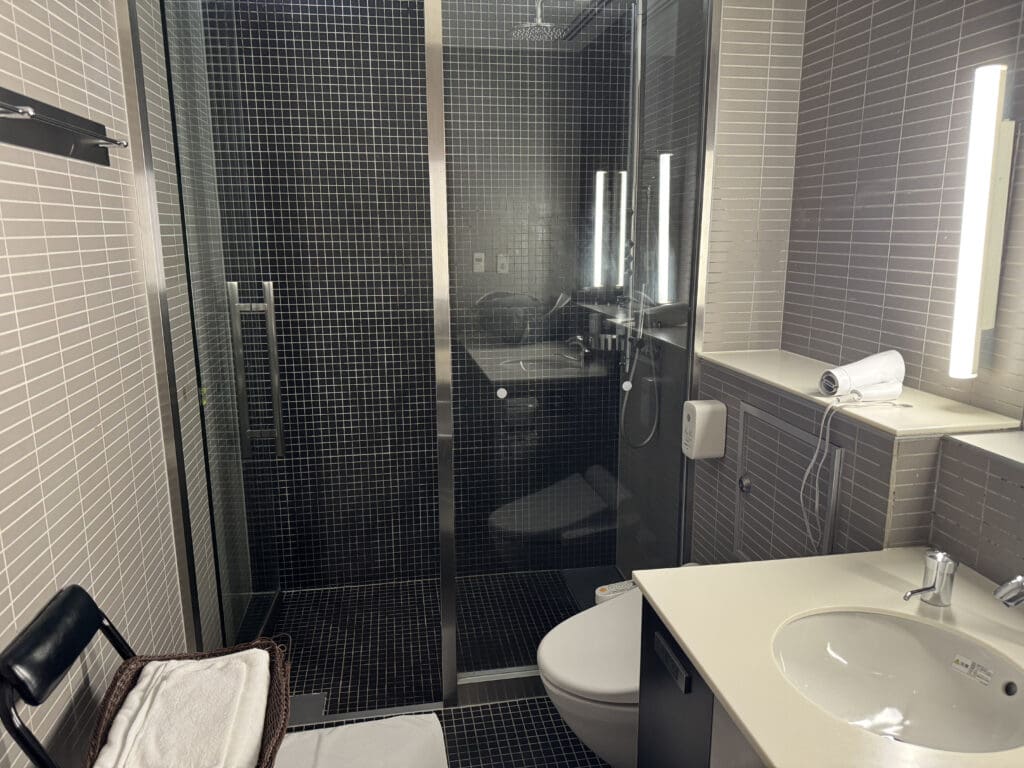 a bathroom with a glass shower door