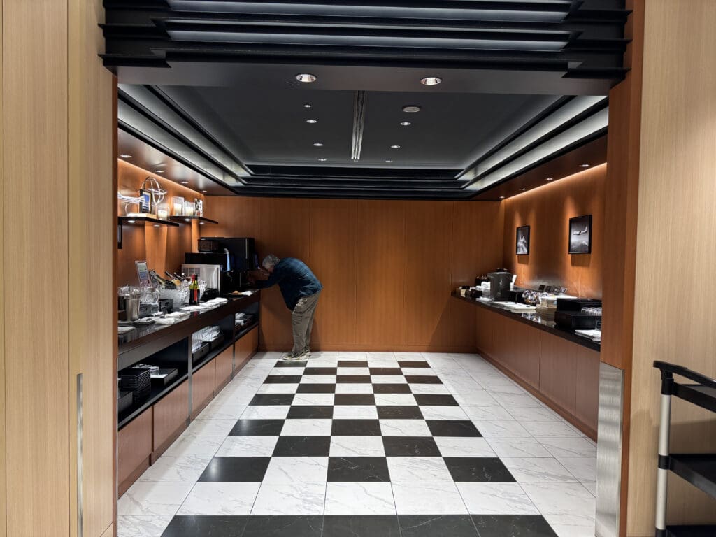 a man standing in a room with a checkered floor
