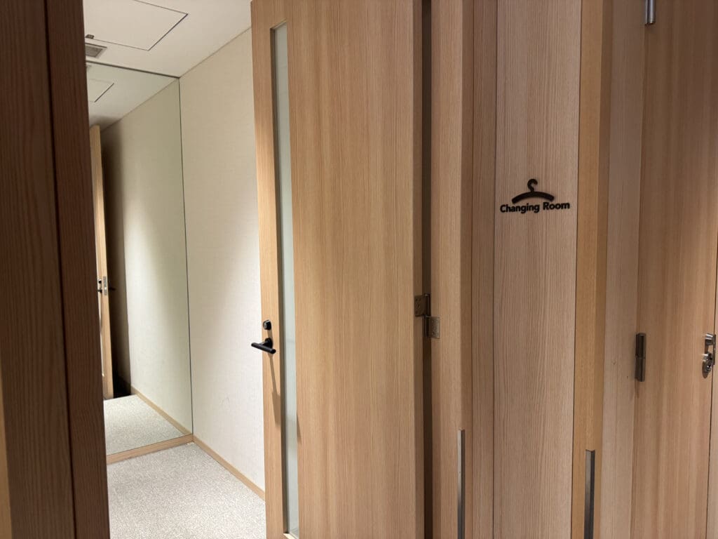 a room with wood doors and a mirror