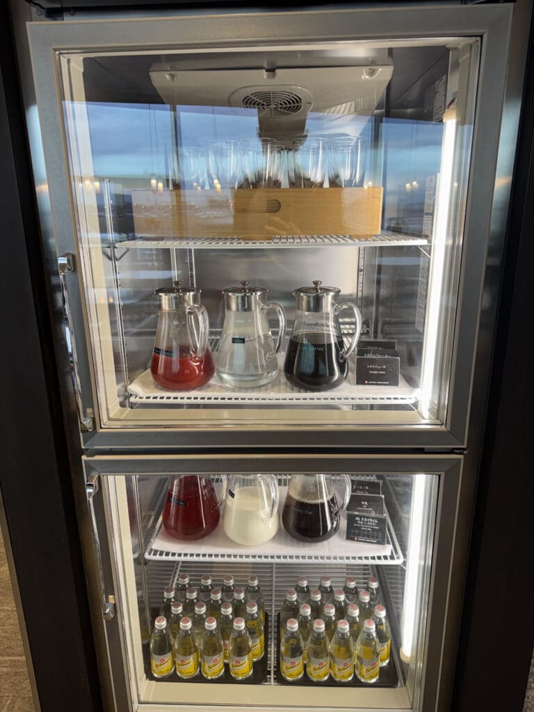 a glass case with drinks and bottles